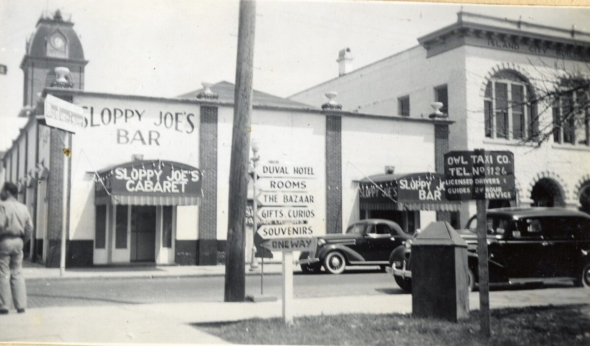 Florida Keys Public Library - Sloppy Joes Bar and Owl Taxi Company at 201 Duval Street. From the DeWolfe and Wood Collection in the Otto Hirzel Scrapbook. 1940s